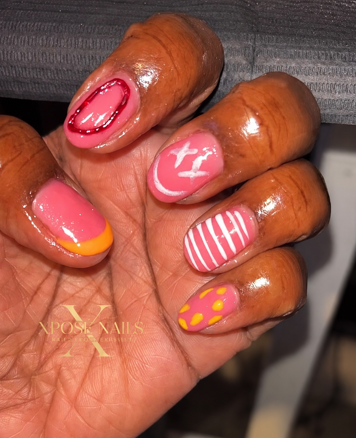 Short pink gel set with hand-painted stripes, dots, and stars